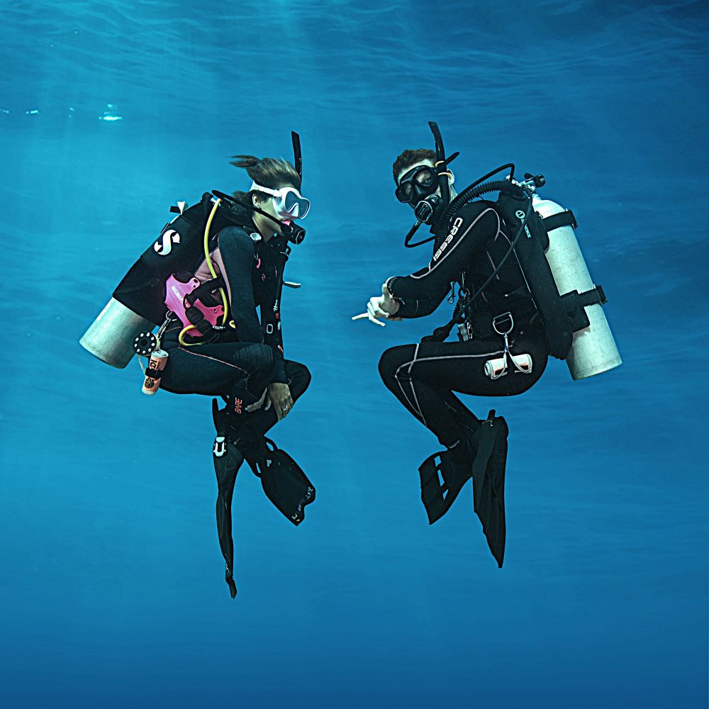 Beginner scuba student standing in shallow pool water
