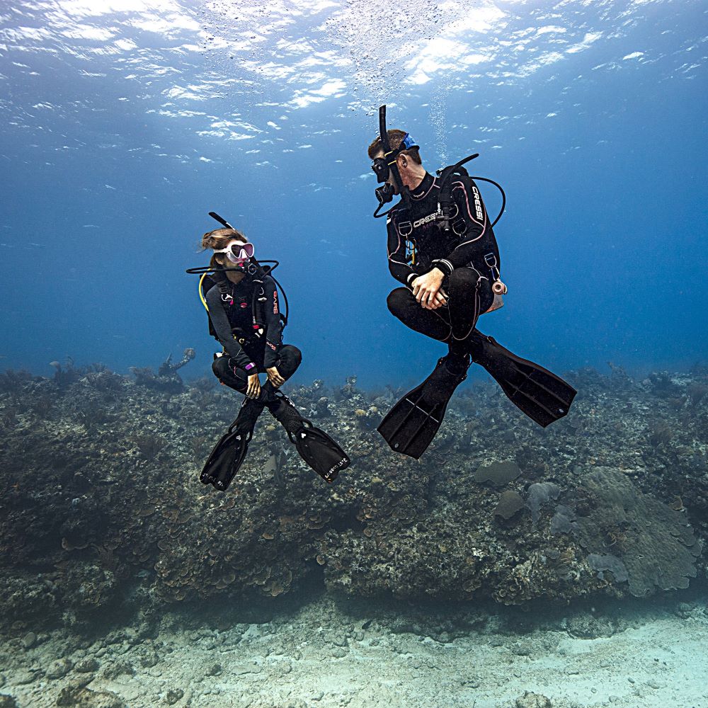 First-time scuba diver learning basic hand signals