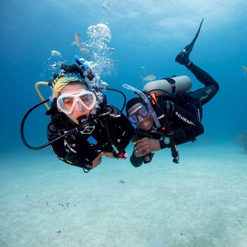 Student and instructor giving okay signs underwater